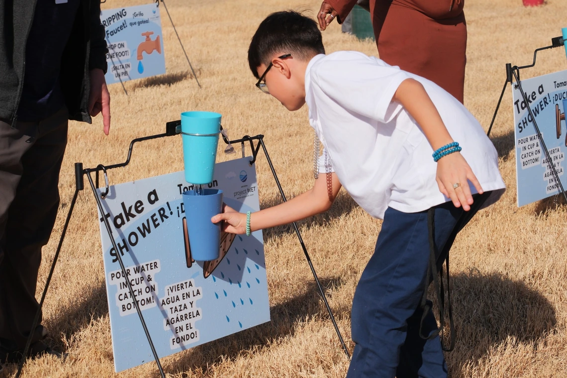 Student catching water at a shower game 